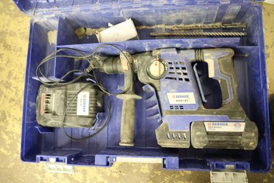 a blue tool box with a hammer, drill, and other tools in it