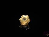 a close up of a gold ring on a black surface