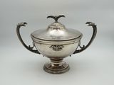 an antique silver plated bowl with a lid and handles