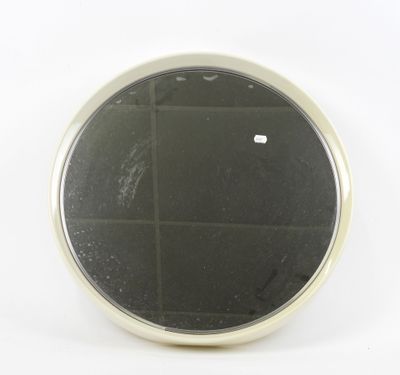an image of a small round mirror on a white surface