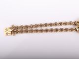 a close up of a gold chain with a lock on it