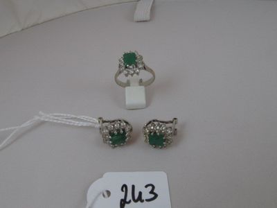 two rings and a pair of earrings are on a white table