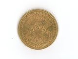 a gold coin on a white surface with a white background