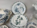 a lot of plates and bowls that are on the table