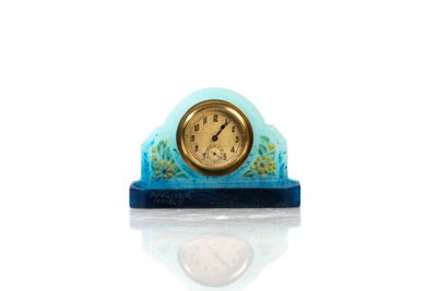 a small clock that is sitting on top of a table