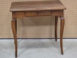a small wooden table with a drawer on top of it