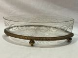 a glass bowl on a stand on a white surface