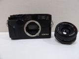 a black camera and a black lens on a white table