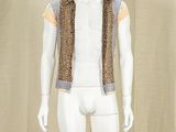 a mannequin wearing a vest and a shirt on display