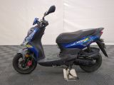 an image of a blue scooter parked on a checkered floor