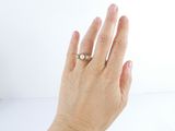 a woman ' s hand with a ring on it ' s finger