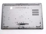 a broken laptop computer sitting on a white surface