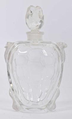 a clear glass bottle with a bird on the top