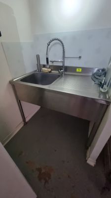 a sink and a refrigerator in a small room