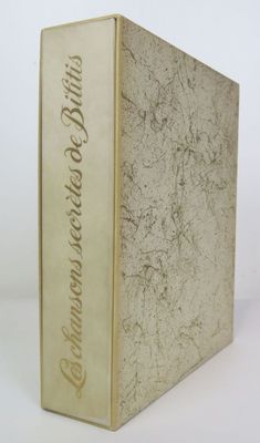 an old book sitting on top of a white table next to a cup of coffee