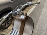 a scooter that is parked on the side of the street