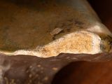 a close up of a piece of pottery on a table