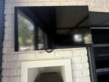 a television mounted on a brick wall above a fireplace