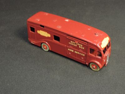 a red toy bus that is sitting on a table