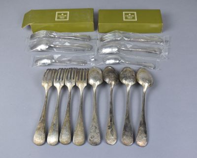 six forks and spoons are sitting on a table next to a box of silverware