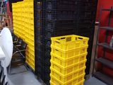 a room with a lot of crates and chairs