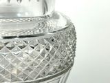a glass vase that is sitting on top of a table