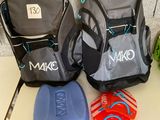 three backpacks that are sitting on a table next to each other
