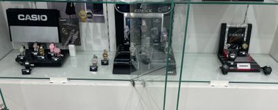 a glass display case with a lot of watches on it