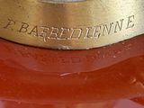 a close up of a gold plated clock on a red surface