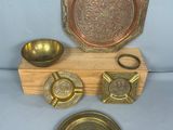 a wooden stand with a plate, bowl, spoon, and other items on it