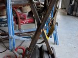 a pile of tools sitting on a table in a garage