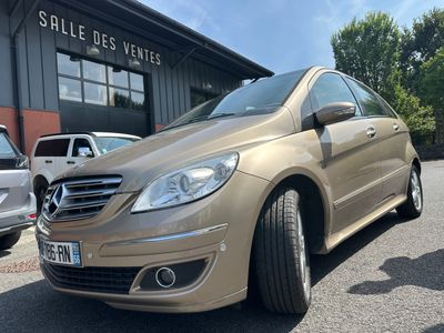 the mercedes b - class is parked in front of a building