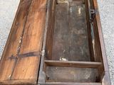 an old wooden box that is open on the ground