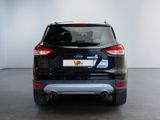 the rear end of a black ford kuga parked in a garage