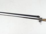 a close up of a sword on a table with a white background