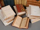 several old books are stacked on top of each other on a table