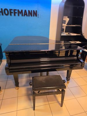 a black piano sitting in a room with a blue wall