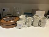 a lot of coffee cups and mugs on the table