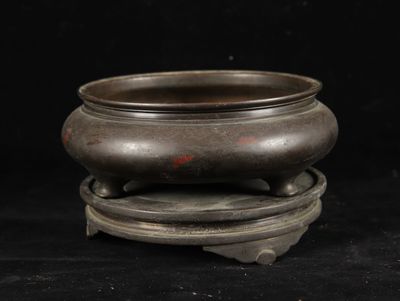 chinese bronze incense bowl on stand on black background