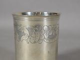 a silver cup that has a design on it