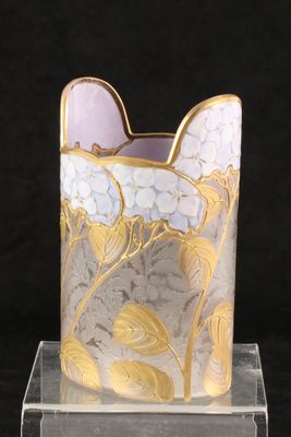 a glass vase with a gold and white design on it