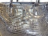 a silver purse that is sitting on a table
