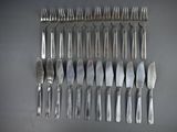 a lot of forks and knives that are on the table