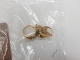 a pair of gold rings and a wallet in a bag