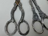 three pairs of scissors sitting next to each other on a table