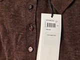 a brown shirt with a tag attached to it ' s collar