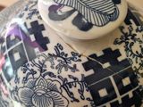 a blue and white bowl with a lid sitting on a table