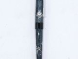 an image of a pen laying on top of a white surface