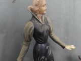 a figurine of a woman and a dog on a table