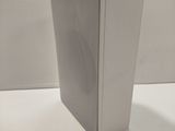 a white book sitting on top of a white table